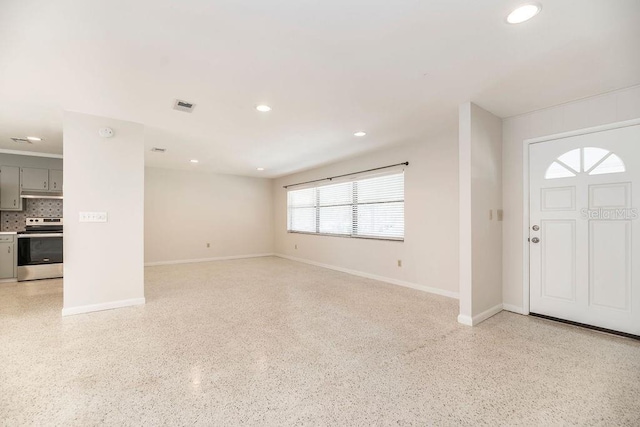 entrance foyer with baseboards, visible vents, light speckled floor, and recessed lighting