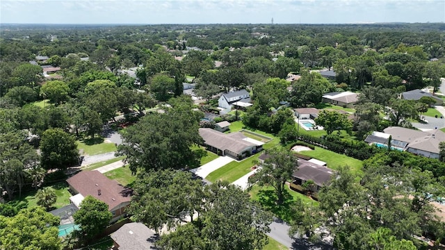 aerial view featuring a residential view and a wooded view