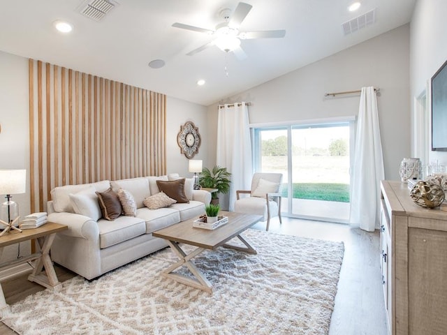 living room with light wood-type flooring, ceiling fan, and lofted ceiling