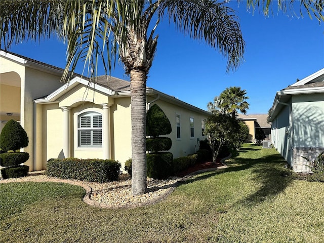 view of property exterior with a lawn