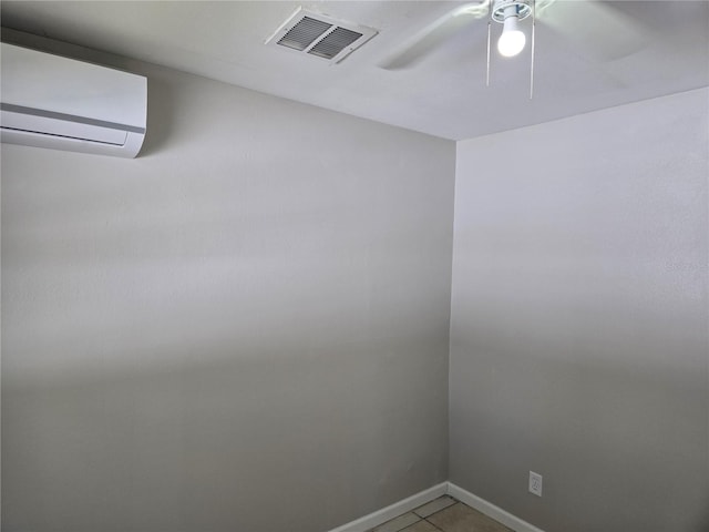 empty room featuring light tile patterned flooring, visible vents, baseboards, ceiling fan, and an AC wall unit