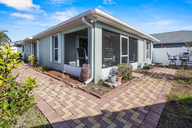 back of house featuring a patio area and a sunroom