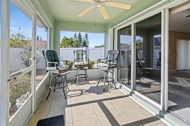 sunroom / solarium featuring ceiling fan