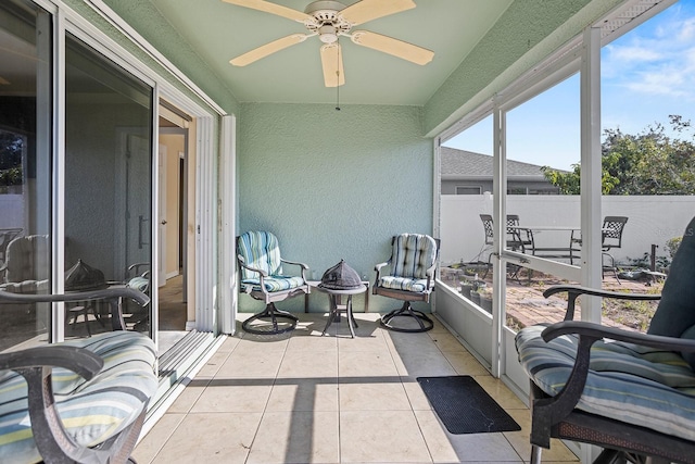 sunroom / solarium featuring ceiling fan