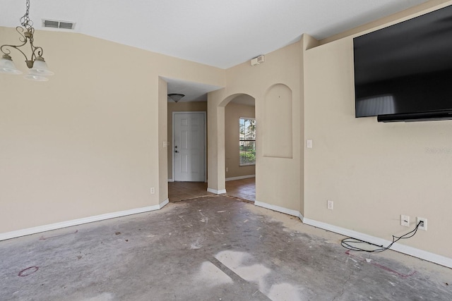 unfurnished living room with a chandelier