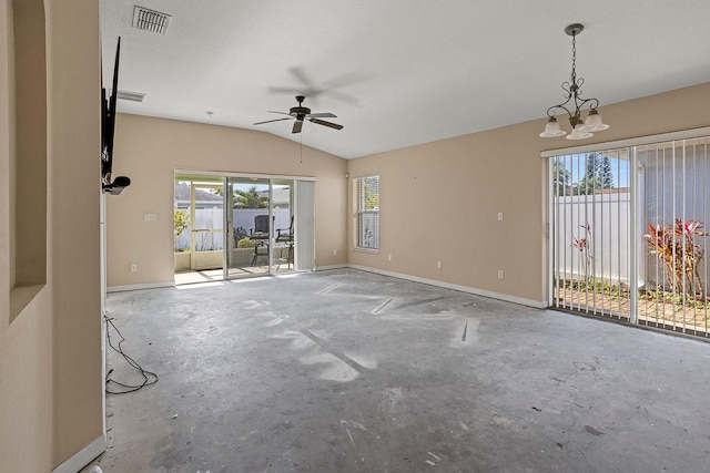 unfurnished room featuring ceiling fan with notable chandelier, vaulted ceiling, and a wealth of natural light