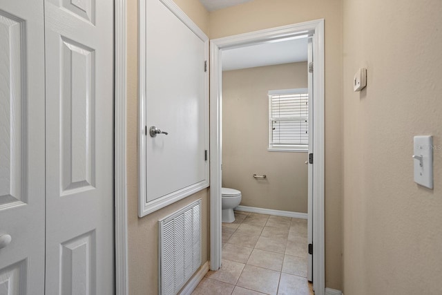 bathroom with tile patterned flooring and toilet