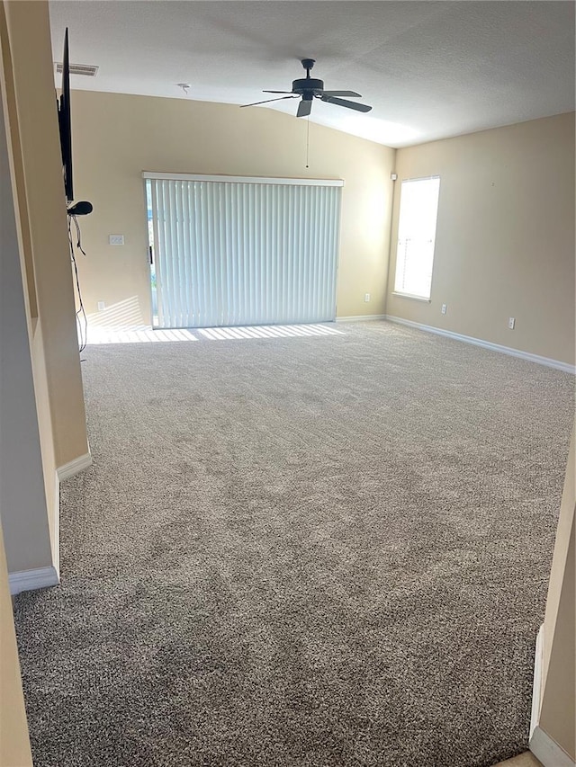 spare room with lofted ceiling, ceiling fan, and carpet flooring