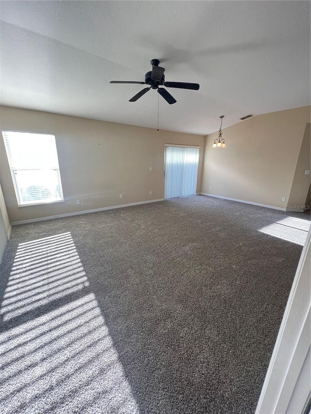 carpeted spare room featuring ceiling fan and a textured ceiling