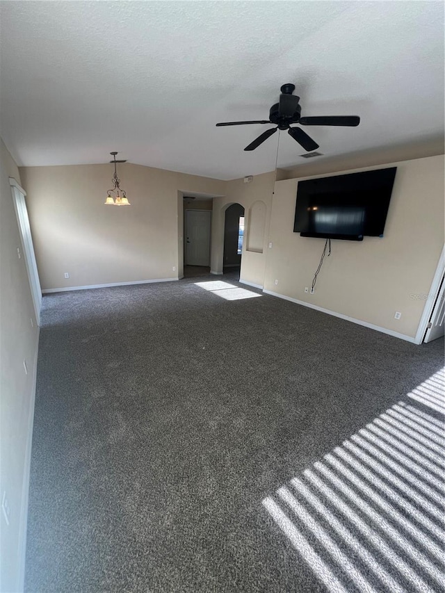 unfurnished living room with ceiling fan, dark carpet, and a textured ceiling