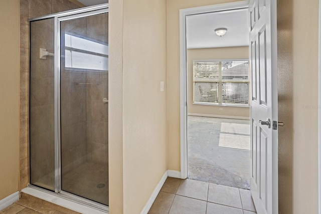 bathroom with tile patterned flooring and an enclosed shower