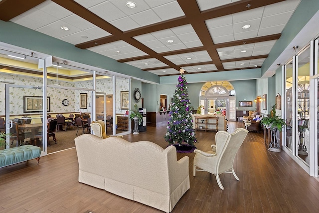 living room with beamed ceiling, wood-type flooring, and coffered ceiling