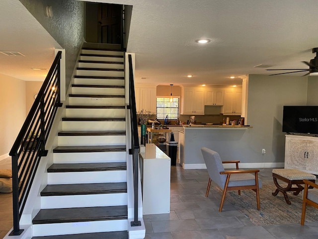 stairway with ceiling fan