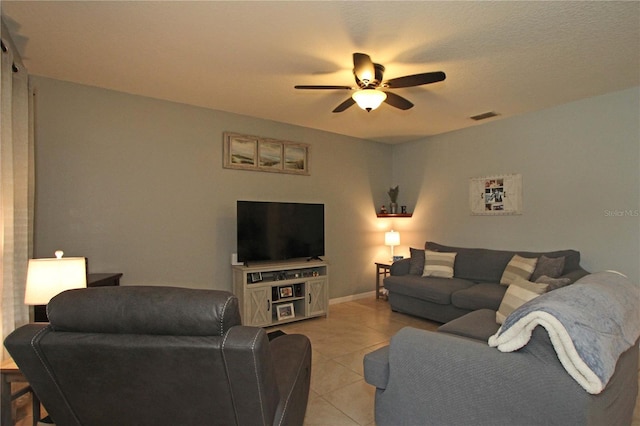 living room with ceiling fan and light tile patterned floors