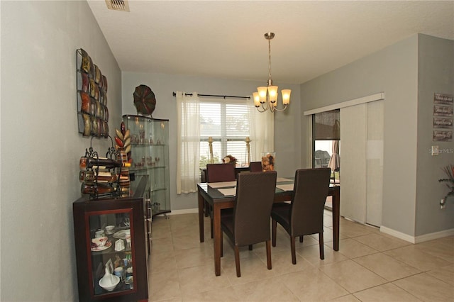 dining room with a notable chandelier and light tile patterned flooring