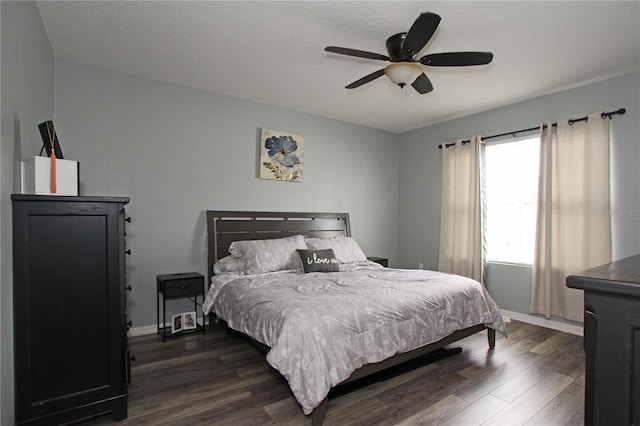 bedroom with ceiling fan and dark wood-type flooring