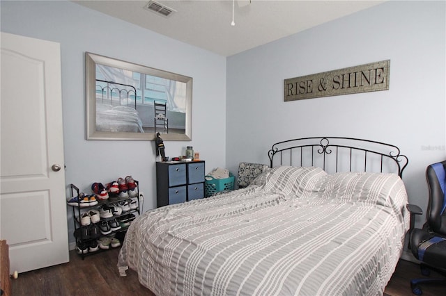 bedroom with dark hardwood / wood-style floors