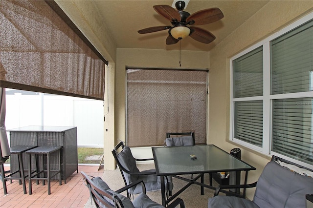 sunroom with ceiling fan