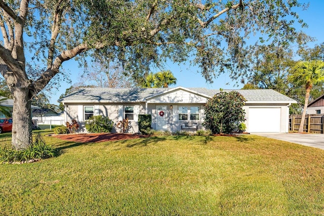 single story home with a front yard and a garage