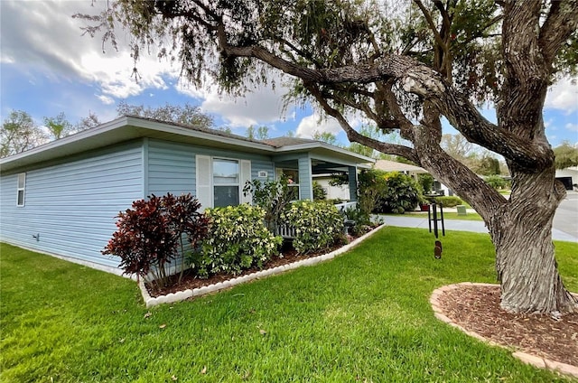 view of side of home featuring a yard