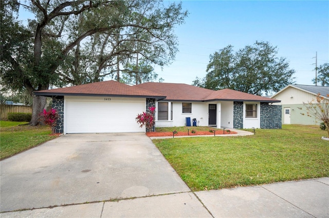 ranch-style house featuring a garage and a front lawn