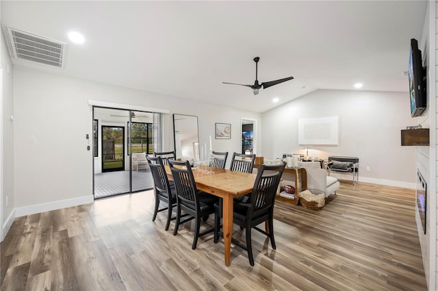 dining space with lofted ceiling, ceiling fan, and light hardwood / wood-style flooring