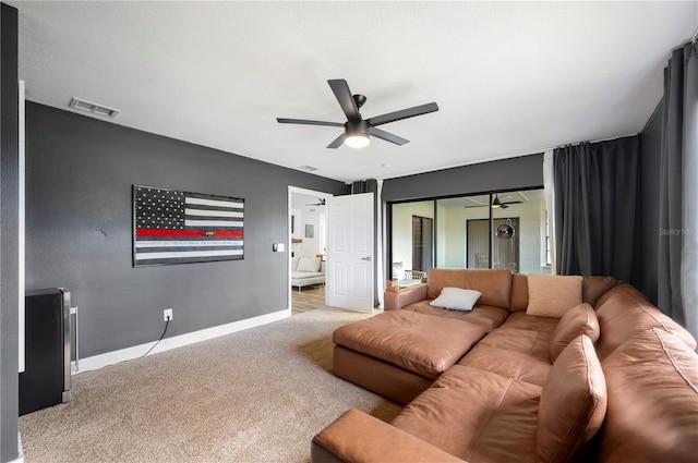 carpeted living room featuring ceiling fan