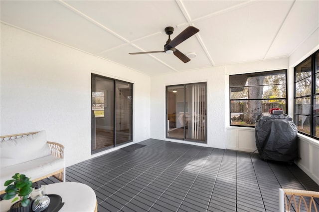 sunroom / solarium featuring ceiling fan