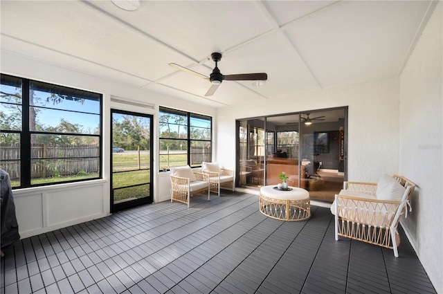 unfurnished sunroom with ceiling fan