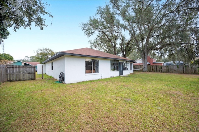 back of house featuring a yard