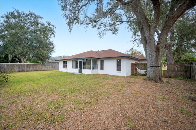 back of house featuring a lawn