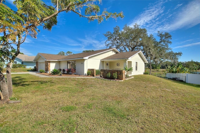 view of front of house featuring a garage and a front lawn