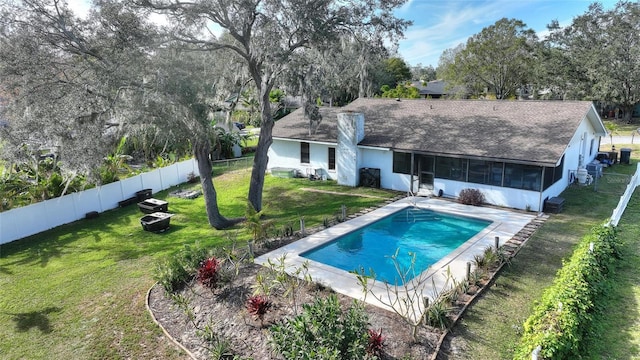 view of pool featuring a lawn and a sunroom