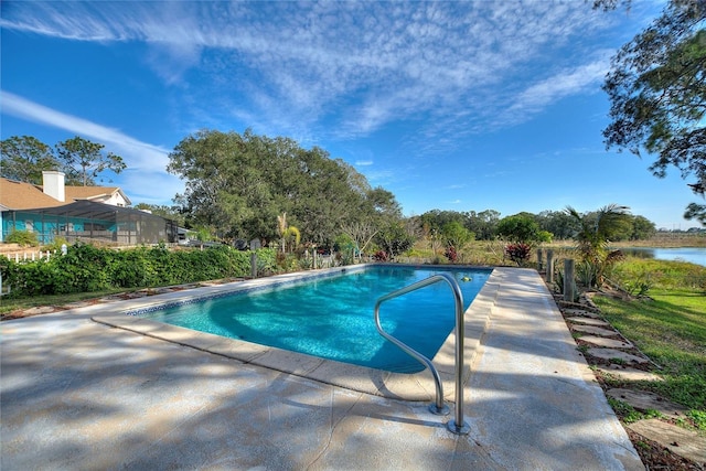 view of swimming pool with a water view and a patio