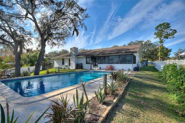 view of pool featuring a lawn