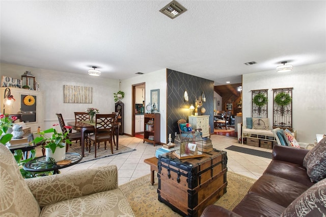 living room featuring light tile patterned floors and a textured ceiling