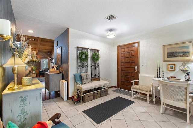 tiled foyer entrance featuring a textured ceiling