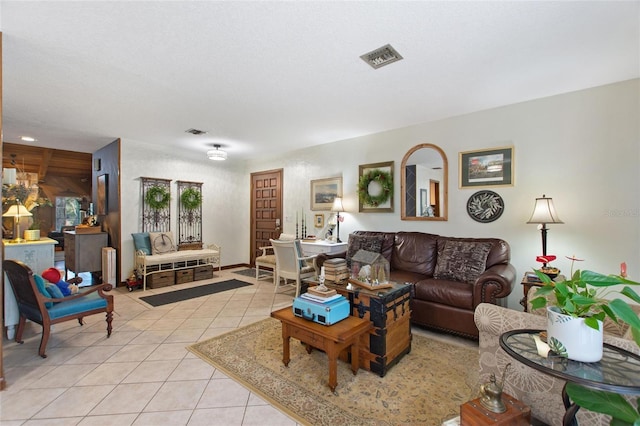 tiled living room featuring a textured ceiling