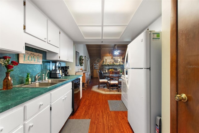 kitchen featuring white cabinetry, sink, black dishwasher, white refrigerator, and wood-type flooring