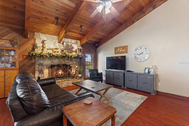 living room featuring dark hardwood / wood-style floors, ceiling fan, a fireplace, beam ceiling, and wood ceiling