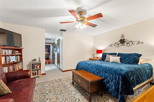 bedroom with ceiling fan and a textured ceiling