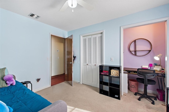 bedroom with ceiling fan and a closet