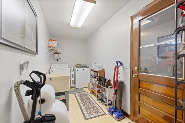 clothes washing area with separate washer and dryer and sink