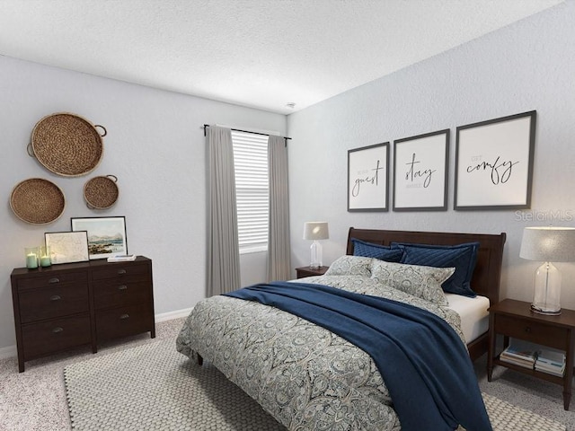 bedroom with a textured ceiling and light colored carpet