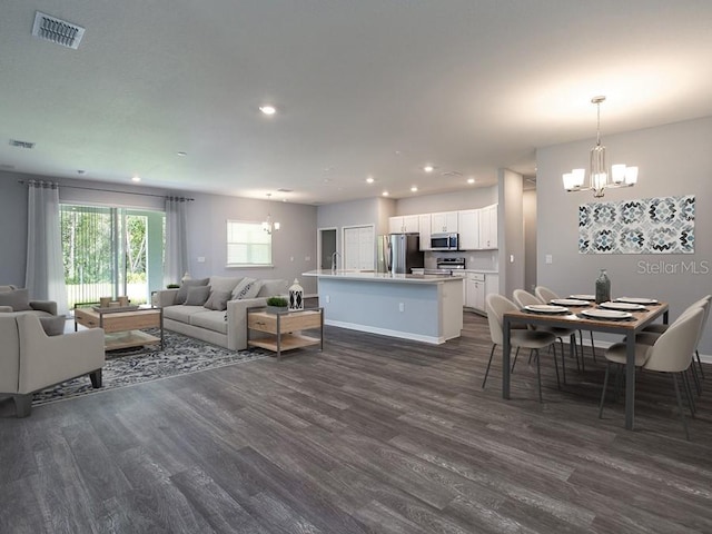 living room featuring a chandelier and dark hardwood / wood-style floors