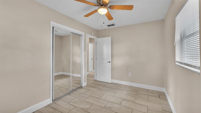 unfurnished bedroom featuring a closet and ceiling fan