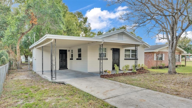 view of front facade with a carport and a front yard