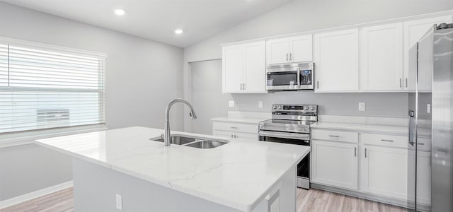 3146 Laurel Oak Ln, Winter Haven, FL 33884 - kitchen featuring appliances with stainless steel finishes, a sink, lofted ceiling, light wood-style flooring, and white cabinets