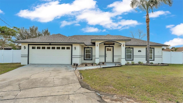 view of front of property with a garage and a front lawn