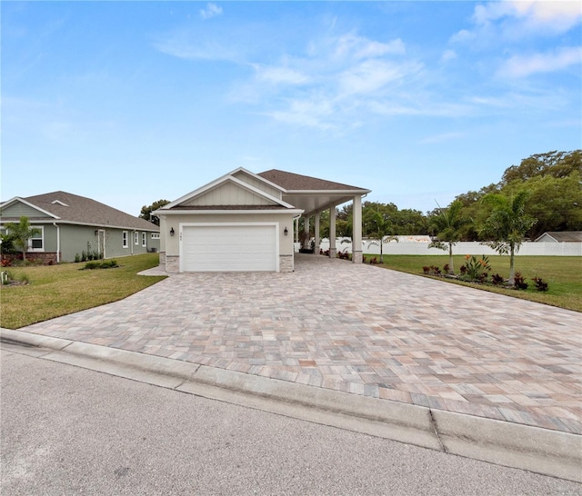 view of front facade with a front yard and a carport